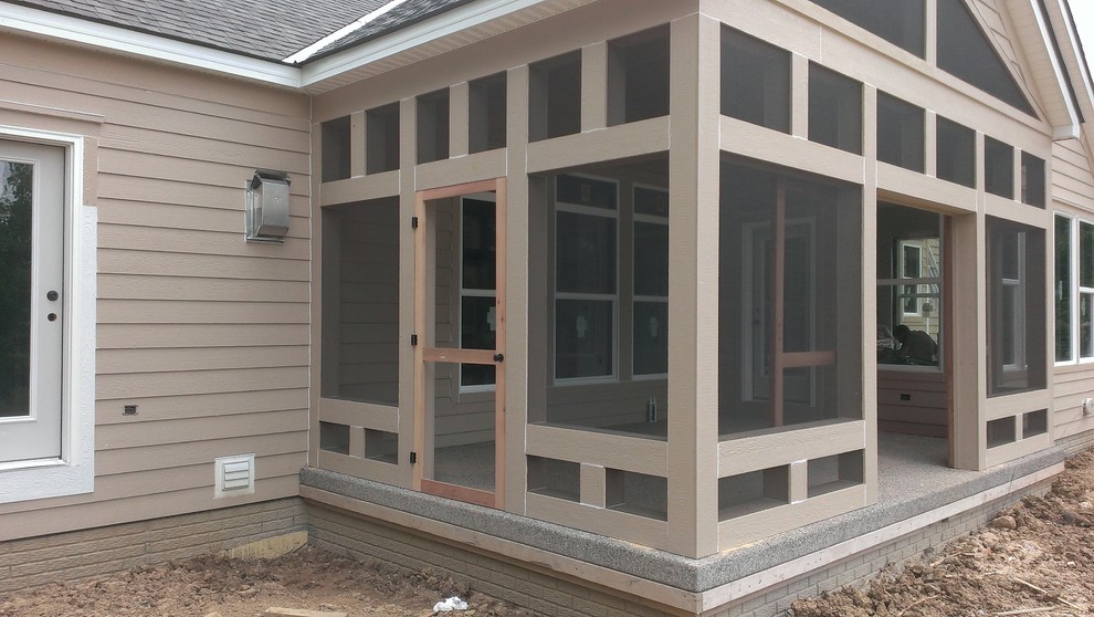 Inspiration for a medium sized contemporary side screened veranda in Columbus with a roof extension.