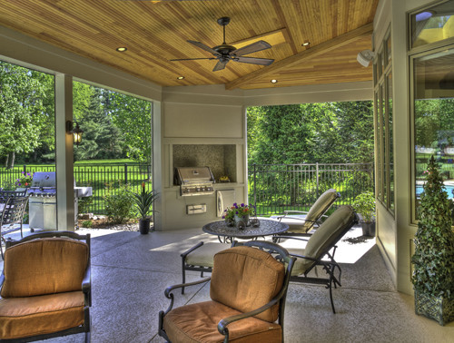 Classic stamped concrete porch idea in St Louis with a roof extension