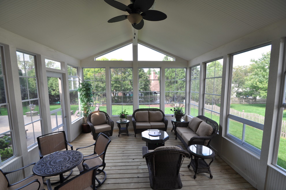 Photo of a modern back screened veranda in Chicago with decking and a roof extension.