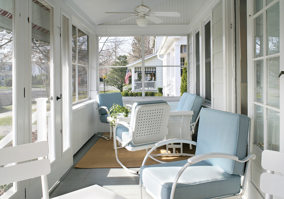 Mid-sized beach style screened-in front porch idea in Newark with decking and a roof extension