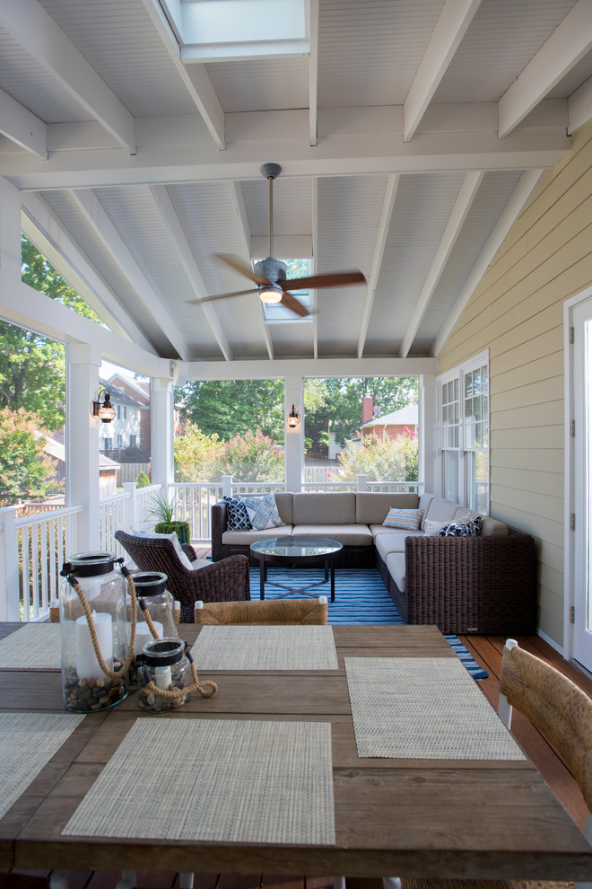 Large classic screened-in back porch idea in DC Metro with decking and a roof extension
