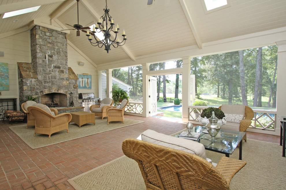 Inspiration for a large timeless brick porch remodel in Atlanta with a fireplace and a roof extension