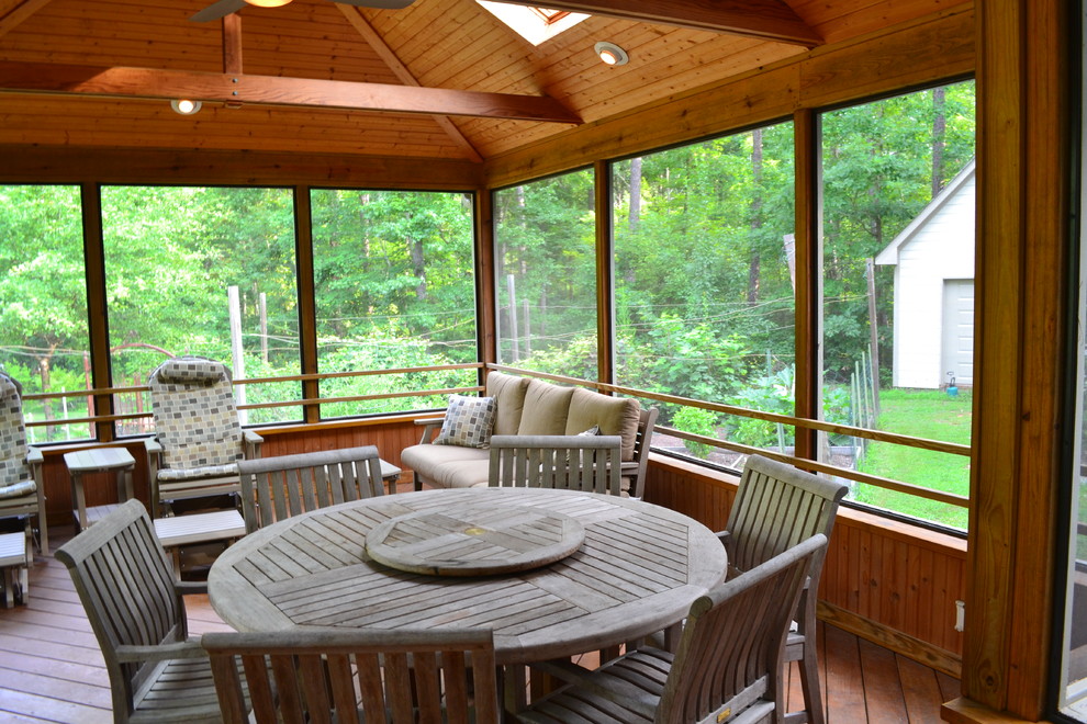 Inspiration for a large traditional back screened veranda in Raleigh with a roof extension.