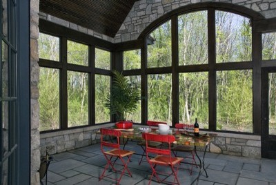 Modelo de porche cerrado clásico extra grande en patio trasero y anexo de casas con adoquines de piedra natural
