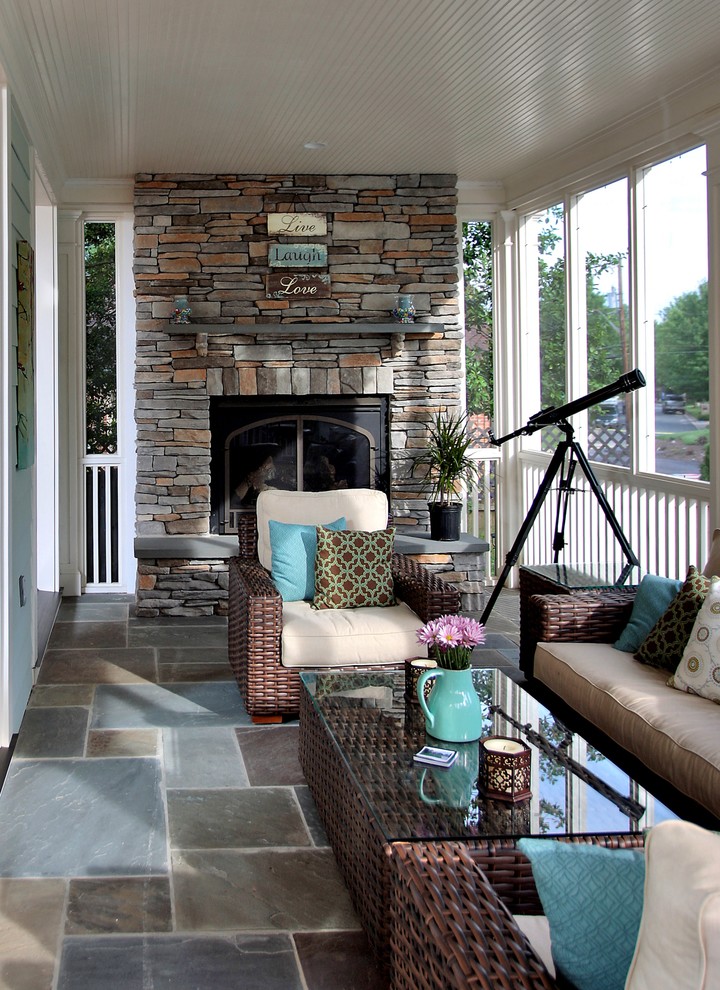 Large classic stone screened-in back porch idea in DC Metro with a roof extension