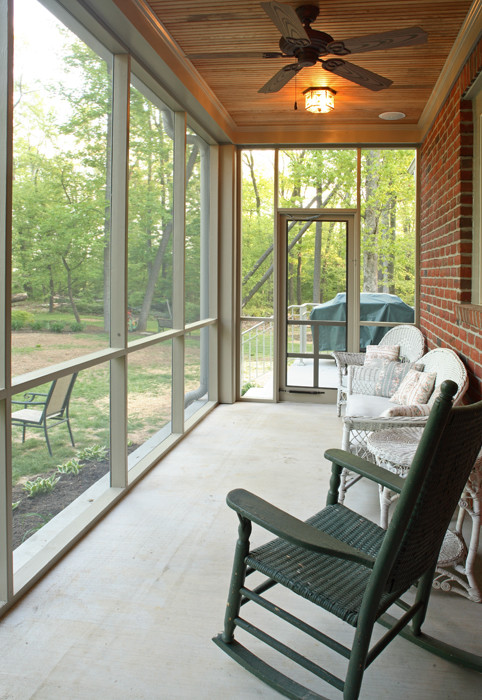 Imagen de porche cerrado de estilo americano pequeño en patio trasero y anexo de casas con losas de hormigón