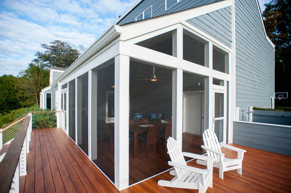 Large transitional screened-in back porch idea in DC Metro with decking and a roof extension