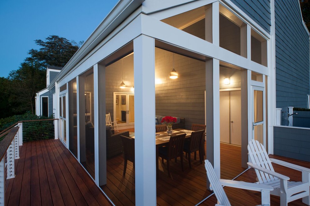 This is an example of a large classic back screened veranda in DC Metro with decking and a roof extension.