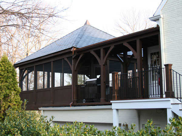 Inspiration for a large rustic screened-in back porch remodel in DC Metro with decking and a roof extension