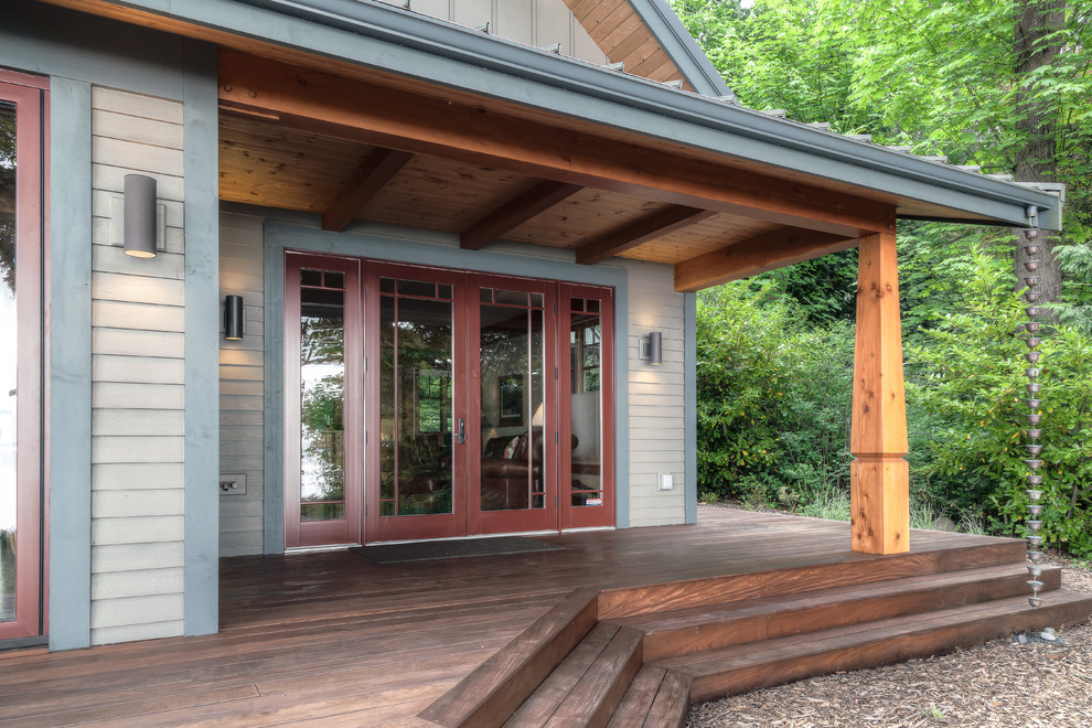 This is an example of a large craftsman back porch design in Seattle with a roof extension and decking.