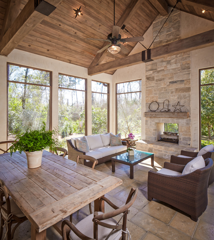 Photo of a classic veranda in Houston with a fire feature and a roof extension.