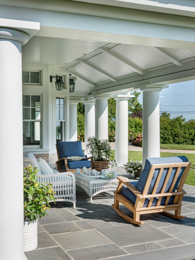 Coastal veranda in Boston with a potted garden and a roof extension.