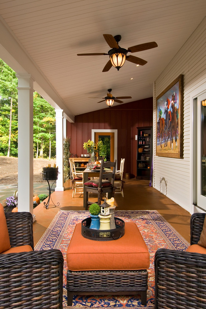 Cottage porch photo in New York with a roof extension
