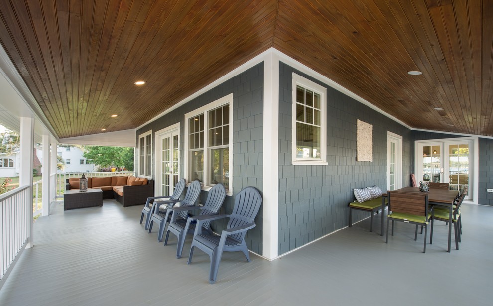 Large beach style side porch photo in DC Metro with a roof extension
