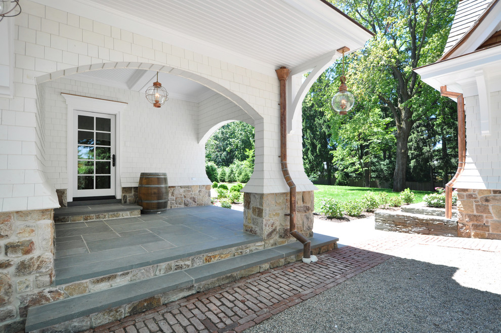 Exemple d'un porche d'entrée de maison chic avec une extension de toiture.