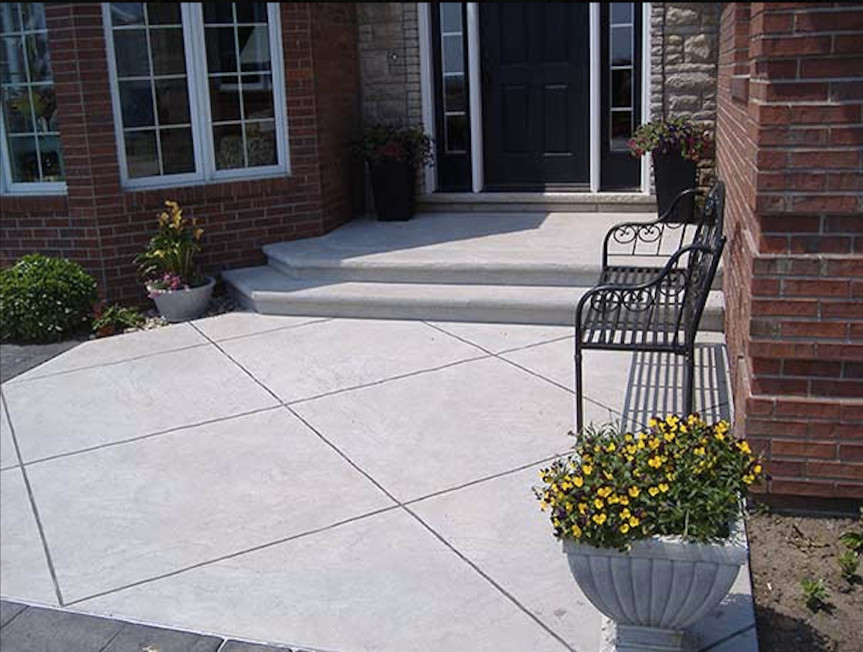 This is an example of a medium sized contemporary front veranda in Chicago with concrete paving.