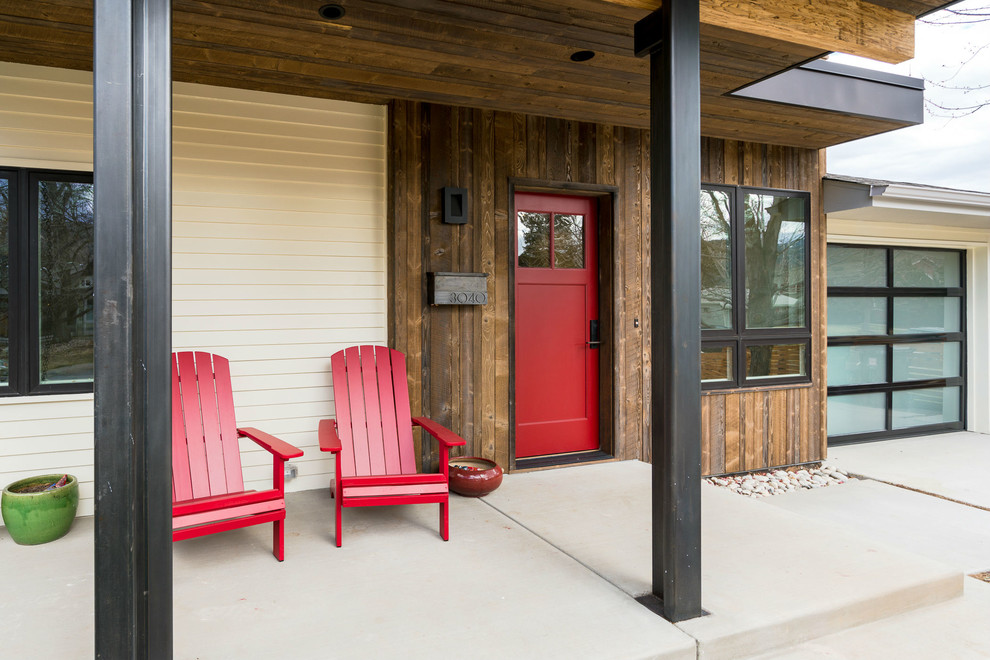 Inspiration for a mid-sized contemporary concrete front porch remodel in Denver with an awning