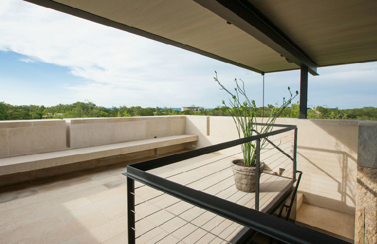 Photo of a small modern veranda in Austin with natural stone paving and a roof extension.