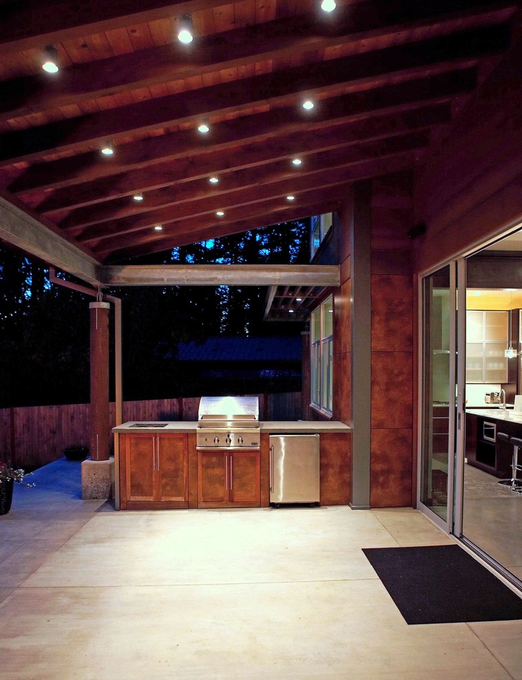 Idées déco pour un porche d'entrée de maison avant moderne de taille moyenne avec une cuisine d'été, une dalle de béton et une extension de toiture.