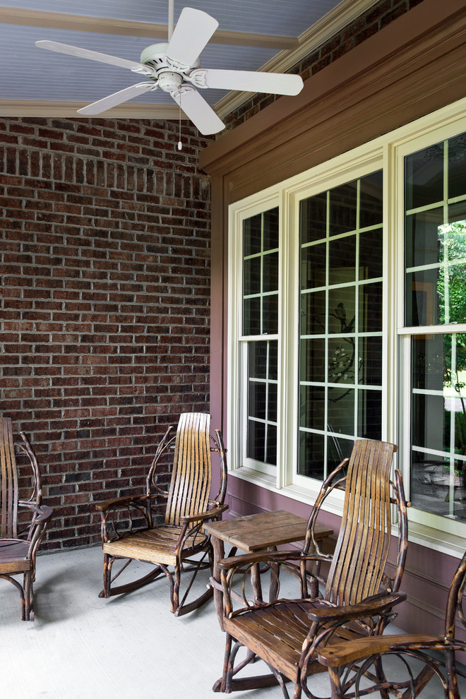 Diseño de terraza clásica de tamaño medio en patio delantero y anexo de casas con adoquines de ladrillo