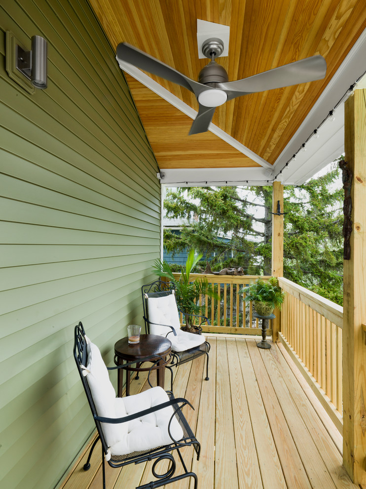 Mid-sized trendy back porch idea in Boston with decking and a roof extension