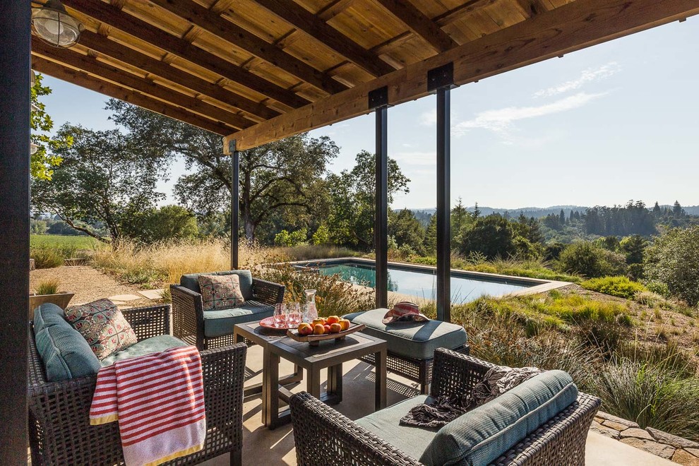 Inspiration for a country veranda in San Francisco with concrete slabs and a roof extension.