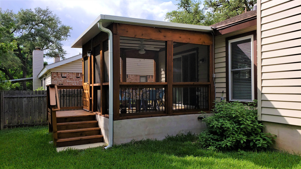 Photo of a medium sized rustic back screened veranda in Austin with a roof extension.