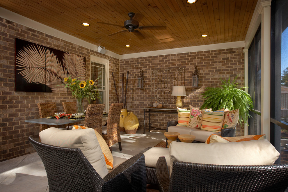Inspiration for a mid-sized tropical tile porch remodel in Charleston with a roof extension