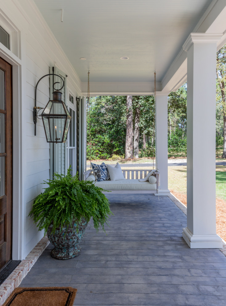 Design ideas for a large traditional front veranda in Atlanta with a roof extension.