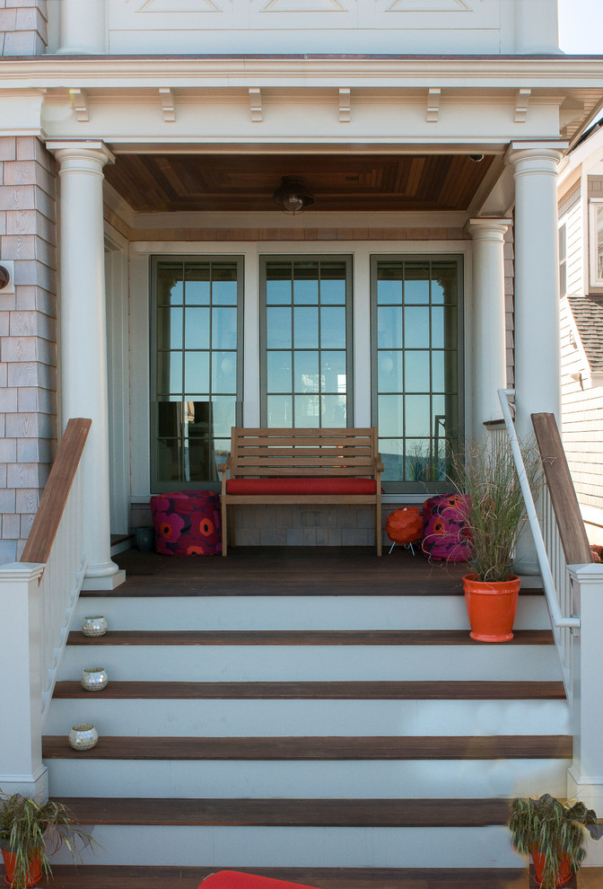 Mid-sized beach style front porch idea in New York with decking and a roof extension