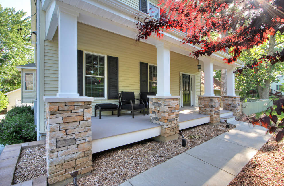 Mid-sized trendy concrete paver front porch photo in St Louis with a roof extension