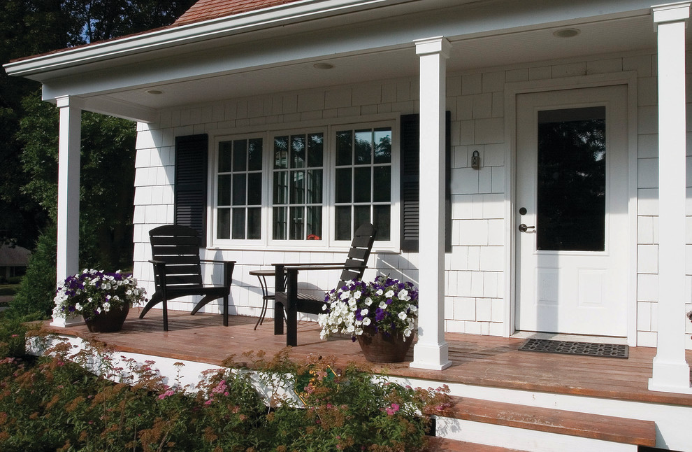 This is an example of a traditional porch design in Minneapolis with decking and a roof extension.