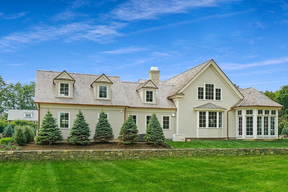 Inspiration for a large timeless stone porch remodel in New York with a roof extension