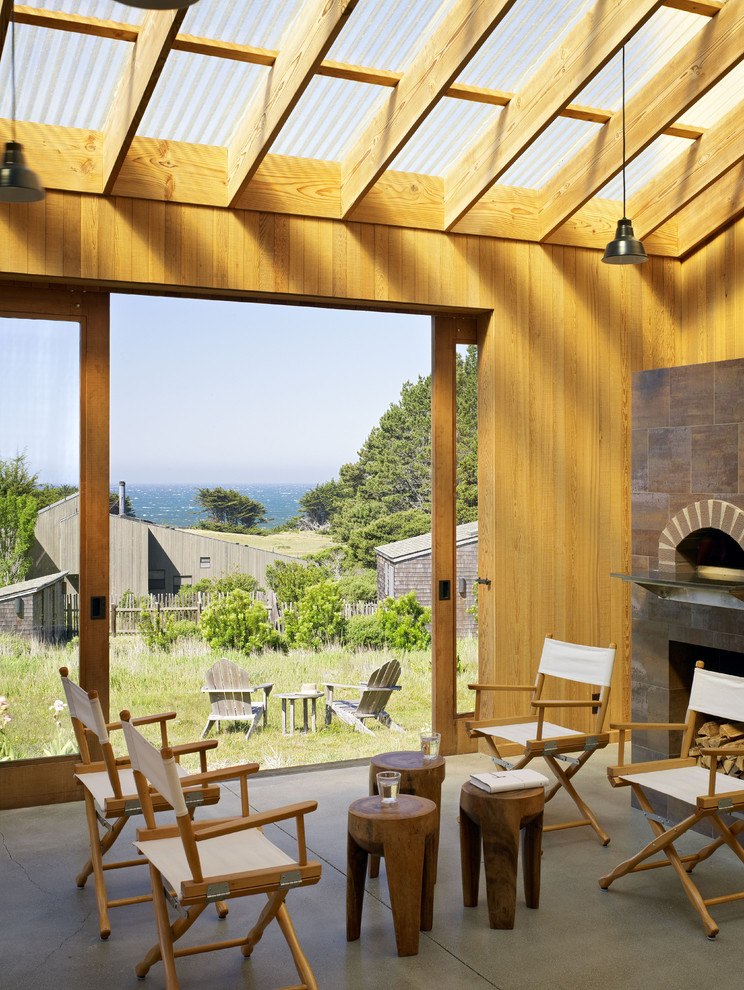 Inspiration for a country veranda in San Francisco with a fire feature, a roof extension and all types of cover.