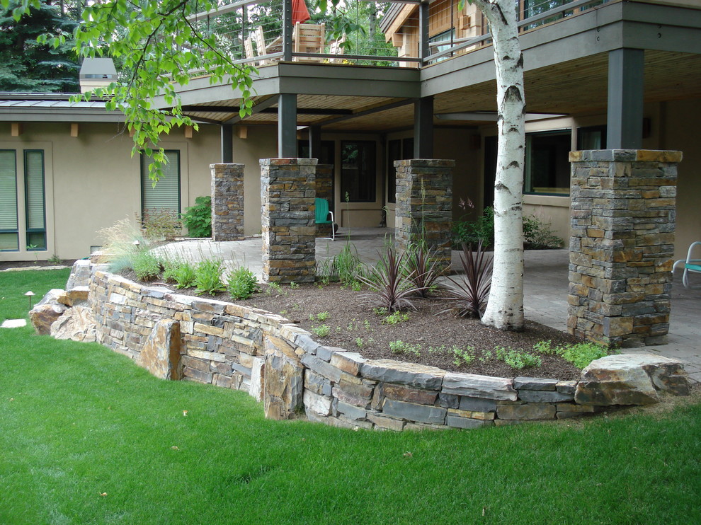 Mid-sized classic stone porch idea in Boise with a roof extension
