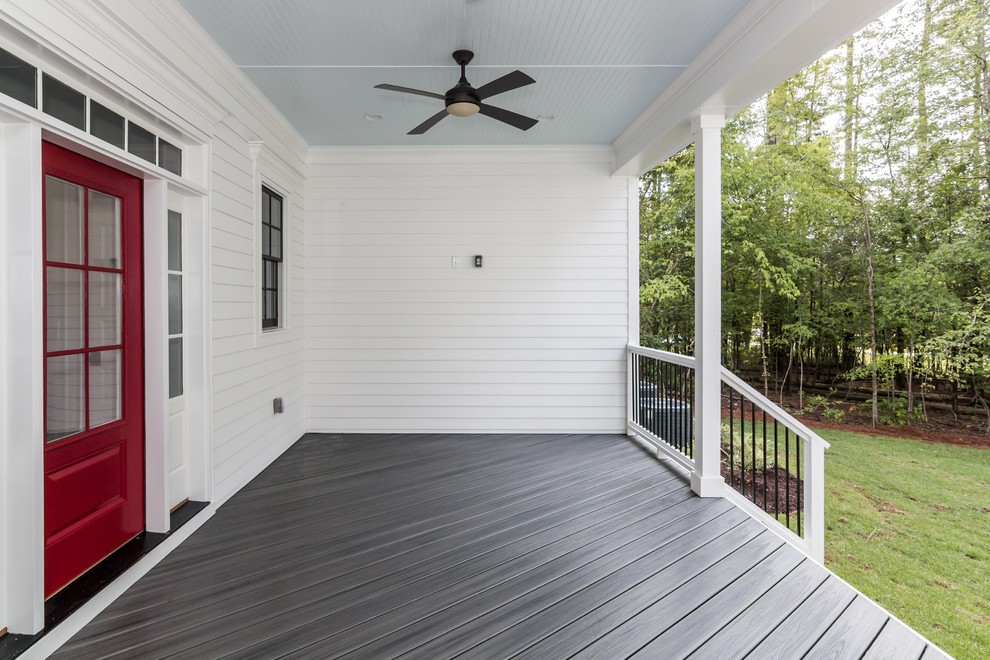 Large farmhouse back porch idea in Raleigh with decking and a roof extension