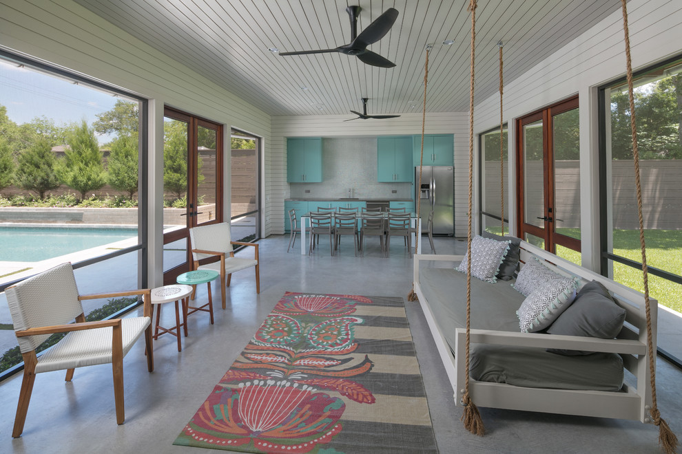 Mid-sized farmhouse concrete screened-in side porch photo in Houston with a roof extension