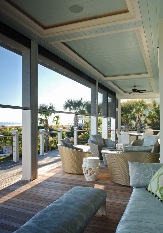 This is an example of a coastal porch design in Charleston with decking and a roof extension.