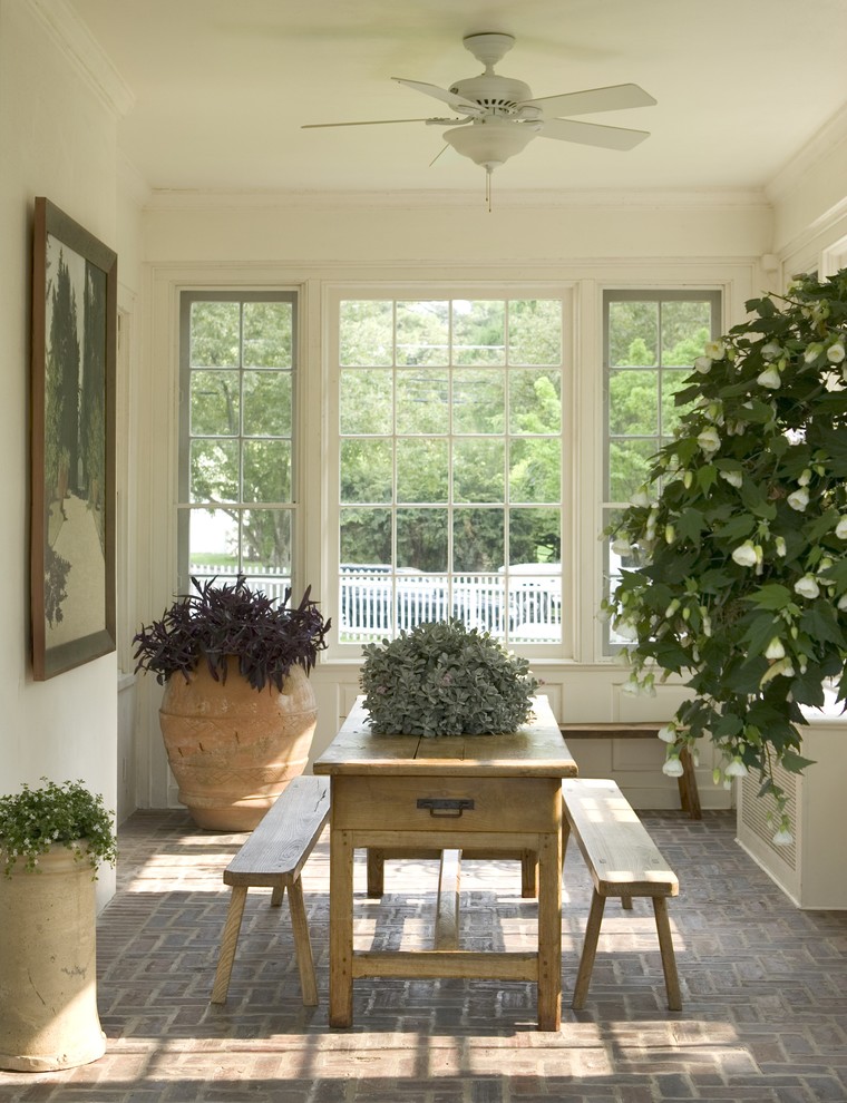 Classic brick porch idea in New York with a roof extension