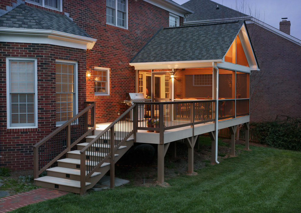 This is an example of a mid-sized traditional back porch design in Charlotte with decking and a roof extension.