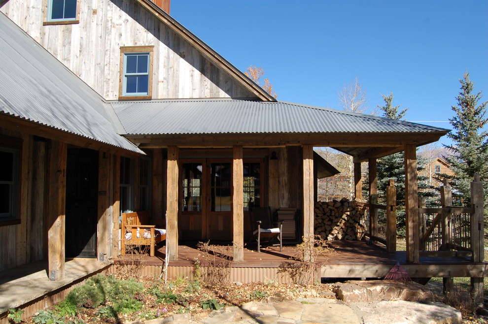 Farmhouse porch photo in Denver with decking and a roof extension