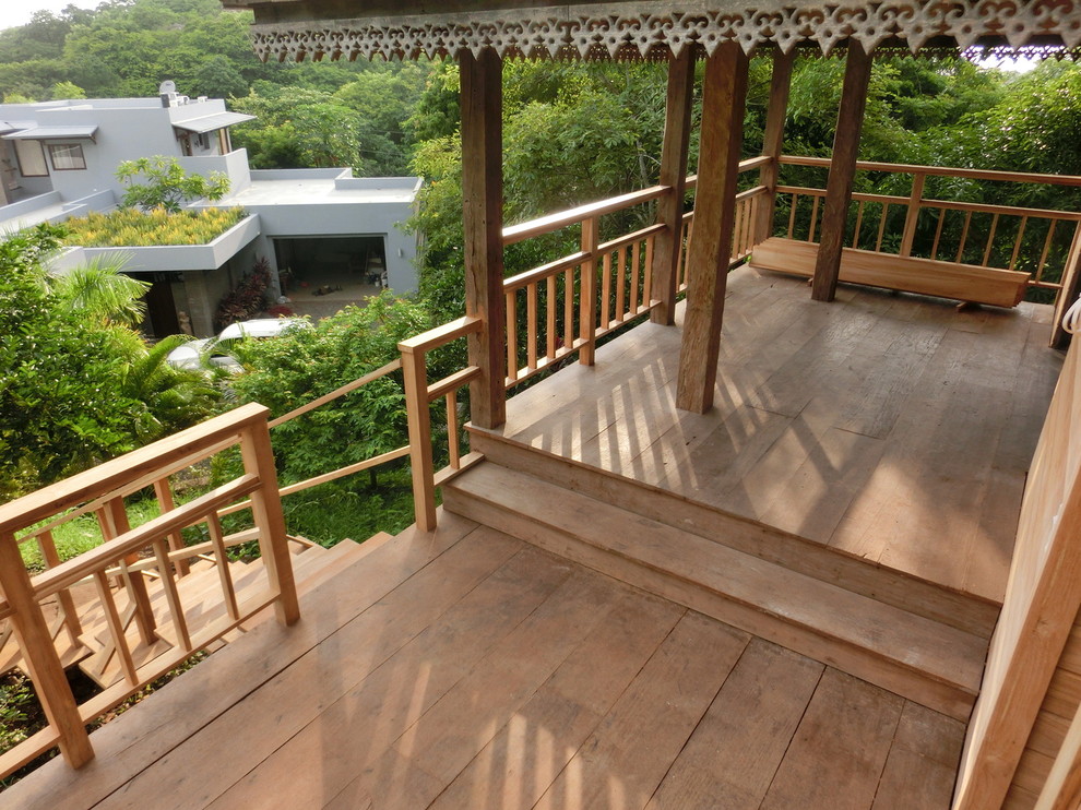 Exemple d'un petit porche d'entrée de maison asiatique avec une terrasse en bois et une extension de toiture.