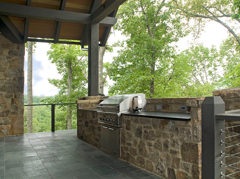 Large elegant tile side porch photo in Other with a fireplace and a roof extension