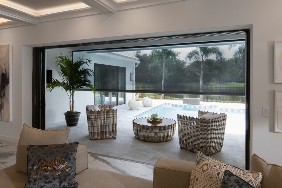 Photo of a large modern back screened veranda in Orlando with concrete slabs and a roof extension.