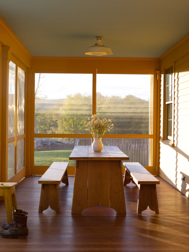 This is an example of a farmhouse screened-in porch design in Bridgeport.