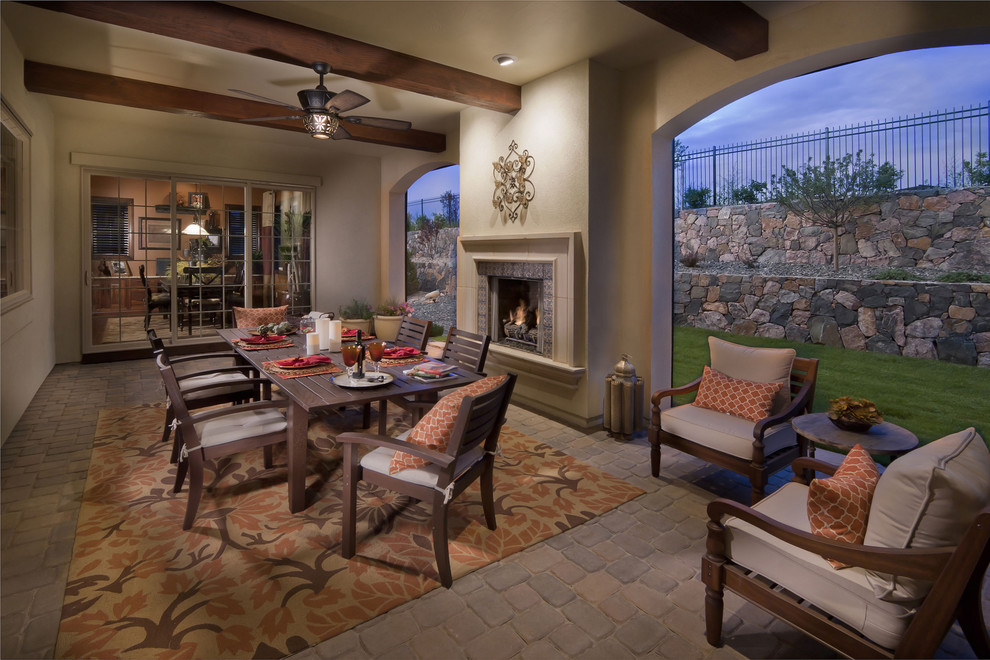 This is an example of a mediterranean back porch design in Denver with a fire pit.