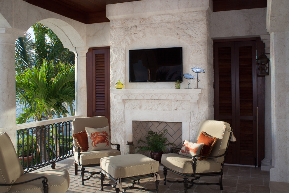 Inspiration for a mediterranean porch remodel in Tampa with a fire pit