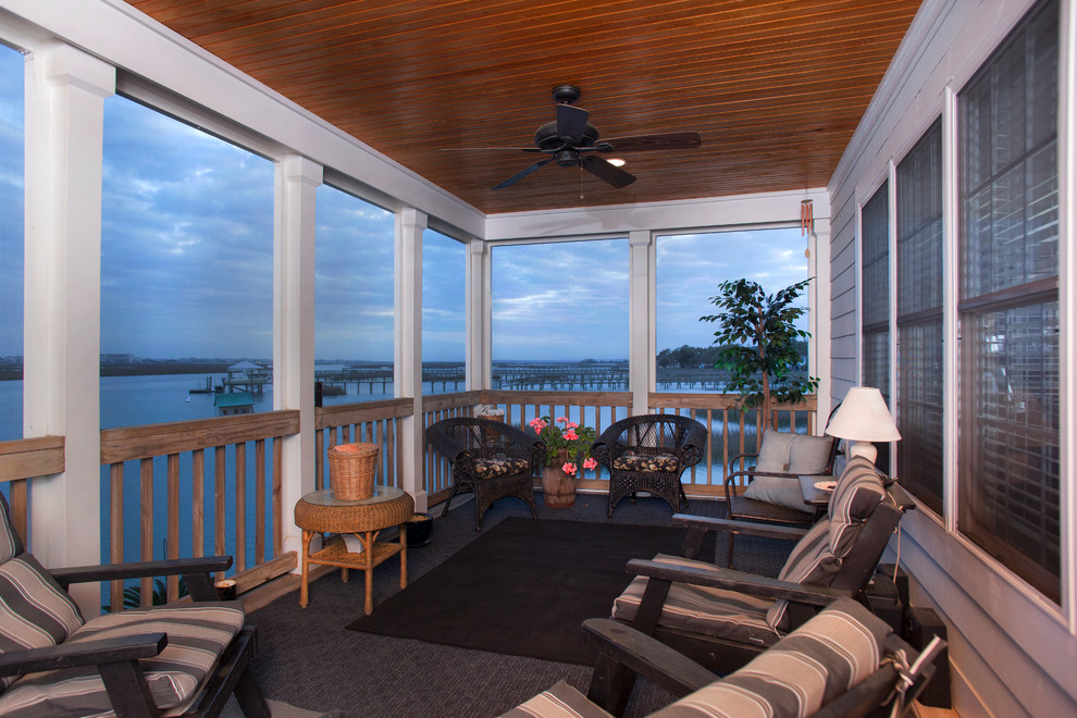 Medium sized nautical front veranda in Charleston with decking and a roof extension.