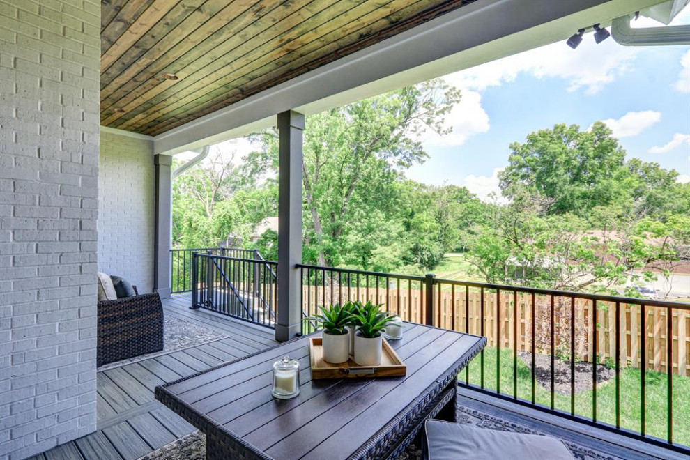 Photo of a classic back veranda in Cincinnati with with columns and a roof extension.