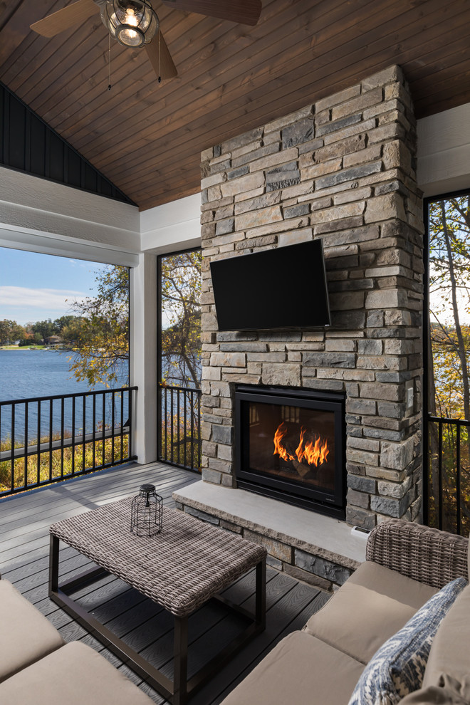 Inspiration for a medium sized coastal back veranda in Grand Rapids with a fireplace and a roof extension.